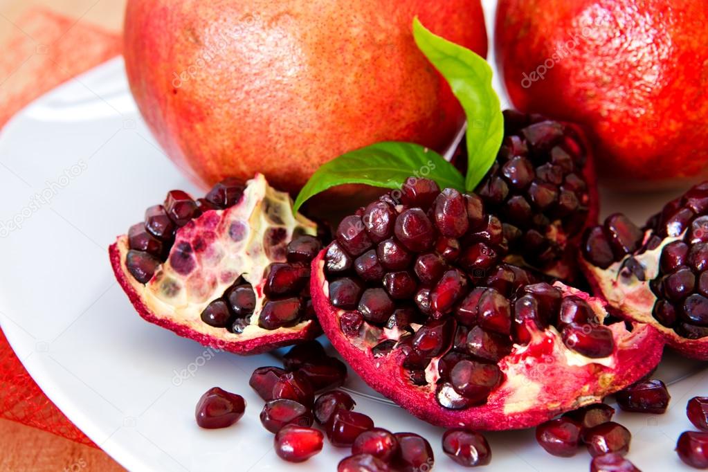 Juicy pomegranates on wood.