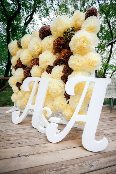Virág pompon hátteret fal, esküvői dekoráció zóna a kettős betűket a. fehér és barna színű. — Stock Fotó