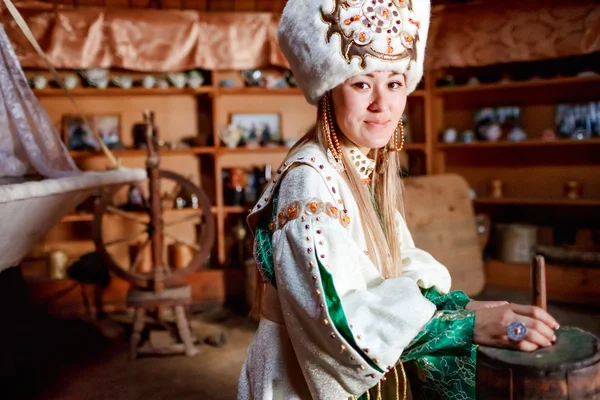 Young woman in traditional yurt dwelling. — Stock Photo, Image