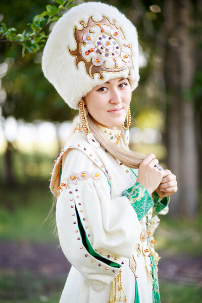 Portrait of girl in traditional festive attire, steppe nomad peoples, outdoors.