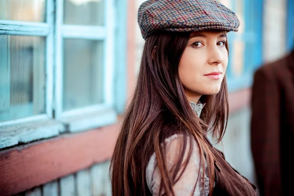 Young woman wearing tweed flat cap old fashioned portrait brown clothes. — Stock Photo, Image