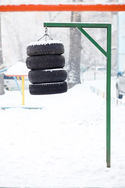 Boxing pear hanging made from the tires chained outdoors. Training and hardening fighting spirit in any weather. Street trainer for a workout, do it yourself. — Stock Photo, Image