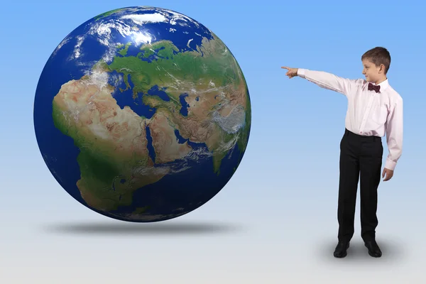 Boy points a finger at the globe — Stock Photo, Image