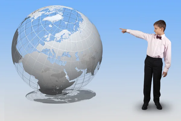 Boy points a finger at a translucent globe — Stock Photo, Image