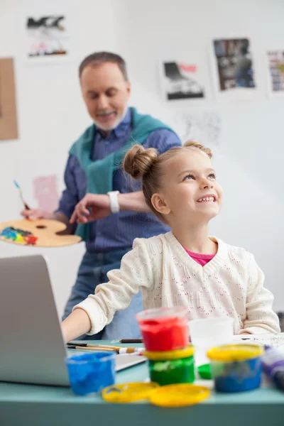 Skillful mature painter and his small granddaughter — Stock Fotó