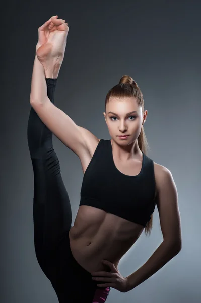 Talented female athlete is exercising in gym — Stock Photo, Image