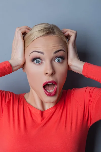 Cheerful blond woman is evincing her shock — Stock Photo, Image