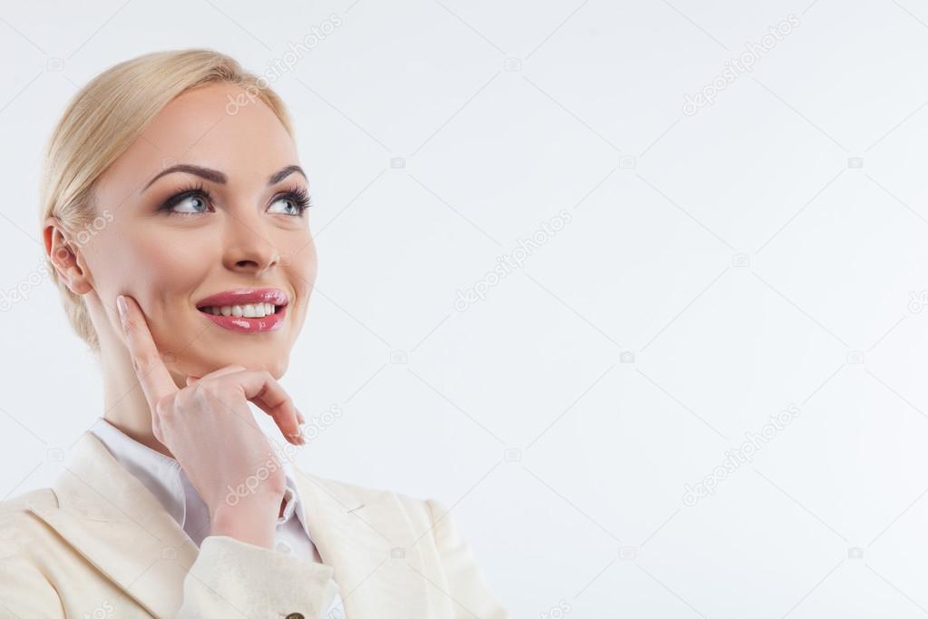 Cheerful young businesswoman is dreaming about future
