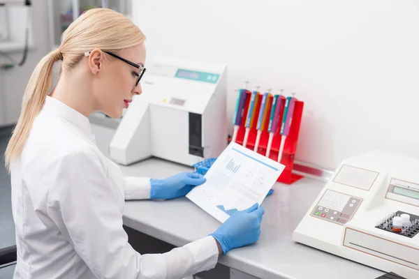 Atractiva joven científica está analizando su investigación — Foto de Stock