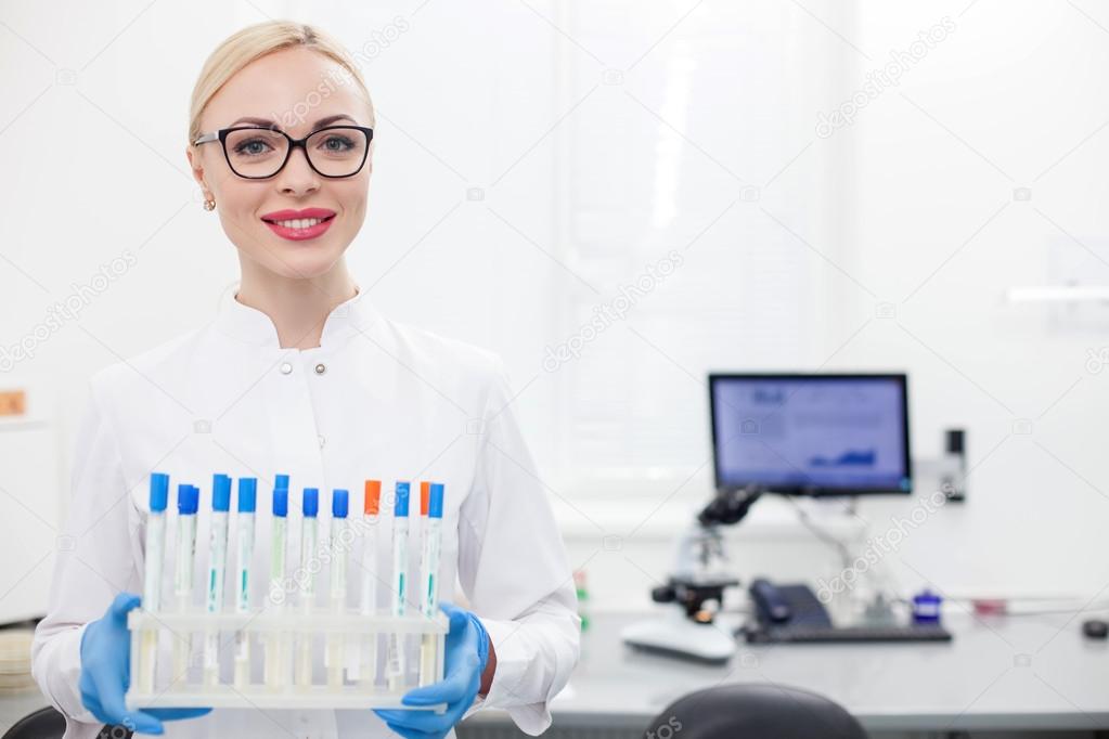 Attractive laboratory assistant with a set of samples