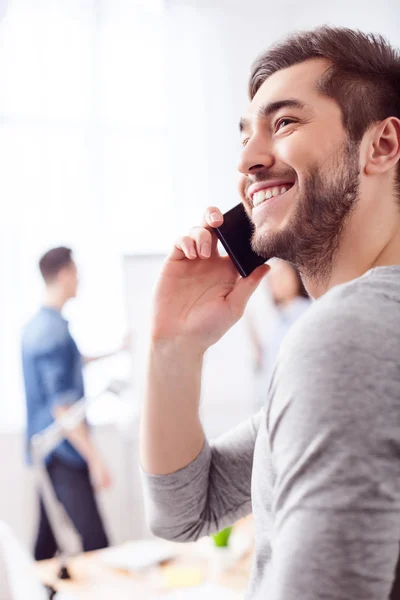 Attractive guy is using telephone for communication — Stock Photo, Image