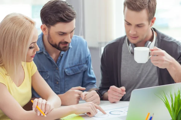 Vrolijke jonge collega's doen papierwerk samen — Stockfoto