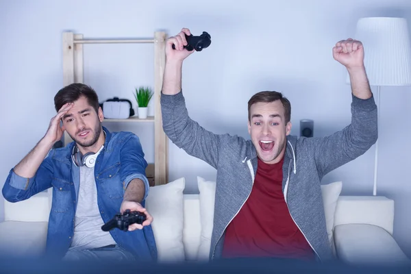 Cheerful two guys are competing in video game — Stock Photo, Image