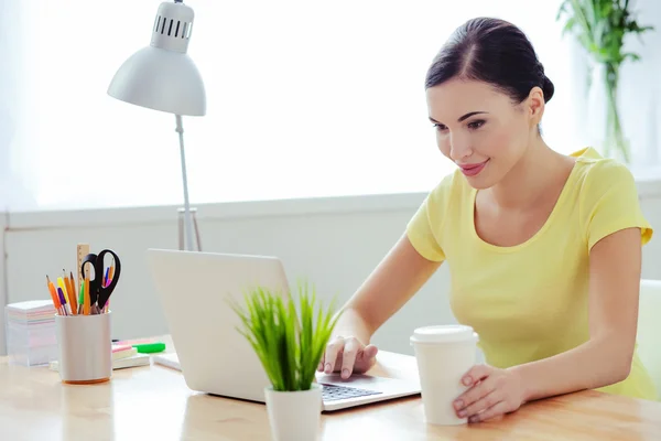 Cheerful young woman is working with laptop — Stock Photo, Image