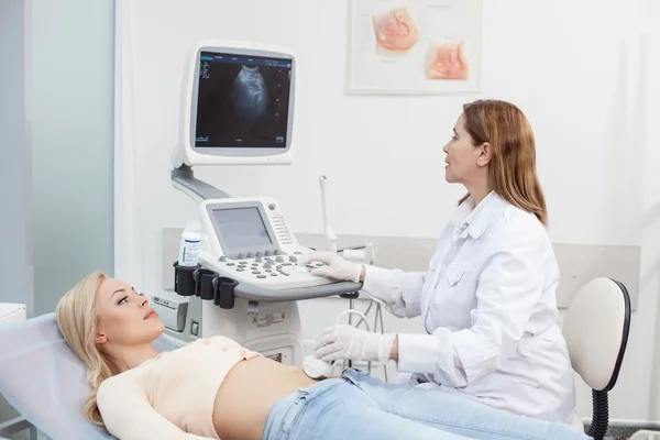 Médico profesional está examinando el abdomen femenino —  Fotos de Stock