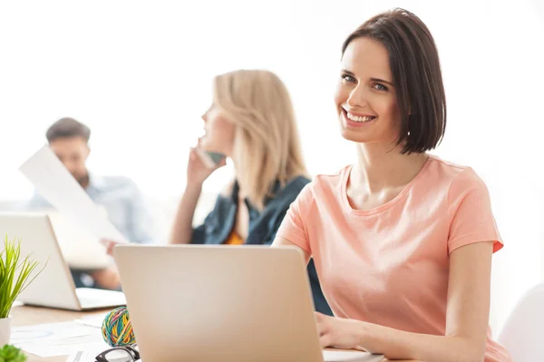 Gut gelaunt arbeiten drei Kollegen im Büro — Stockfoto