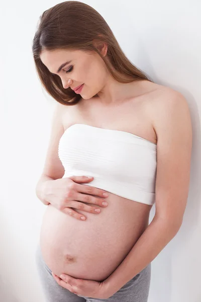Cheerful future mother is expecting for her child — Stock Photo, Image
