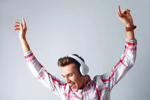 Cheerful guy is enjoying cool song — Stock Photo, Image