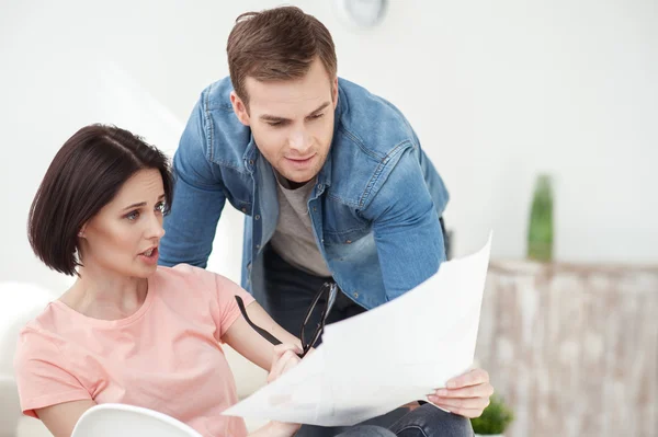 Cheerful family is doing paperwork at home — Stock Photo, Image