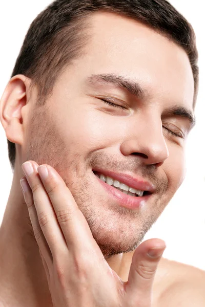 Cheerful unshaved guy is caring of skin — Stock Photo, Image