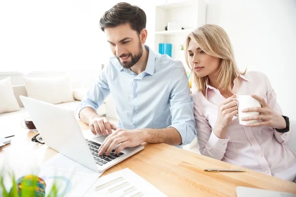 Cheerful young workers are using modern technology — Stock Photo, Image