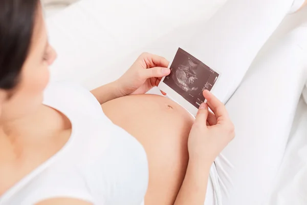 Cute expectant mother with an ultrasonic picture — Stock Photo, Image