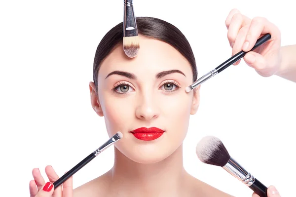 Cheerful healthy girl is doing facial make-up — Stock Photo, Image