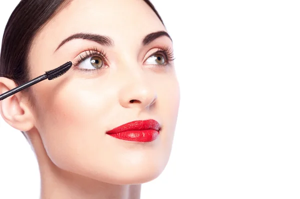 Cheerful brunette girl is doing make-up — Stock Photo, Image