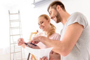 Young couple holding color palette