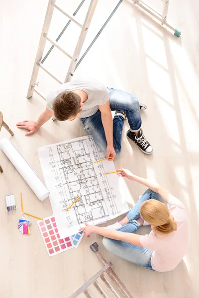 Family discussing a plan of their new home