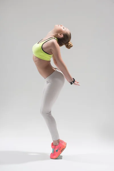 Cheerful female athlete is doing warm-up — Stock Photo, Image