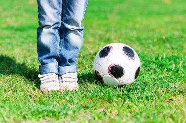 Futbol oyunu oynayan sevimli küçük erkek çocuk