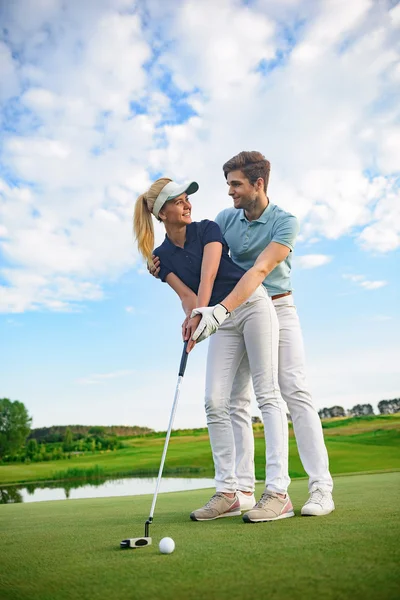 Jovem casal em campo de golfe — Fotografia de Stock