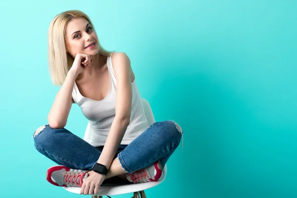 Cheerful blond girl is sitting with anticipation — Stock Photo, Image