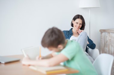 Young teenage boy studying at desk