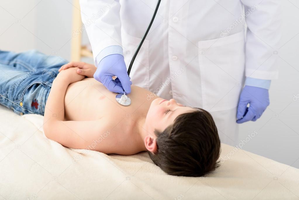 Pediatrician doing checkup on young boy