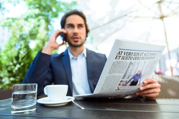 Successful young businessman communicating on telephone — Stock Photo, Image