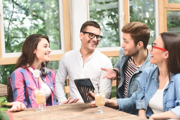 Group of friends enjoying talking together — Stock Photo, Image