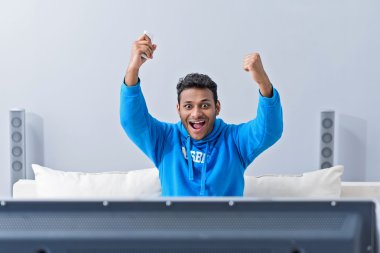 Young attractive african man watching television