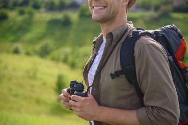 Young traveler enjoying vacation on field