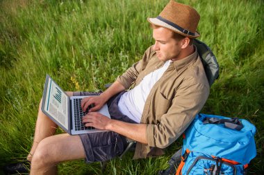 Young man using computer in nature