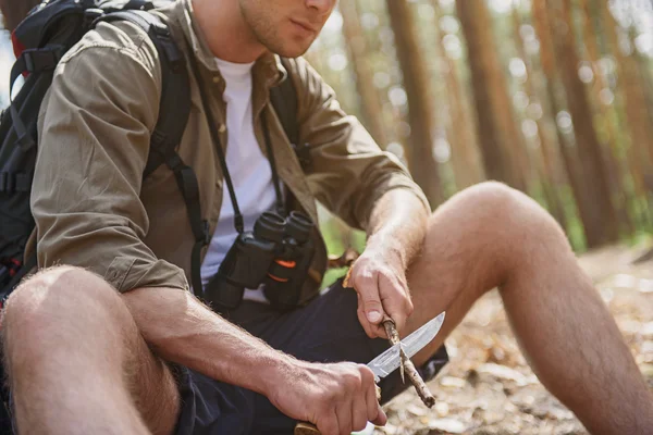 Cheerful male tourist preparing wood — Stock Photo, Image