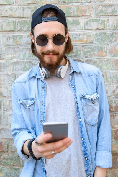 Cool kille med smartphone utomhus — Stockfoto
