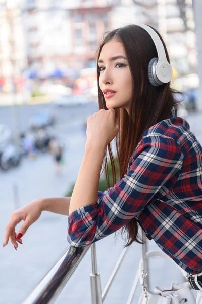 Dreamful girl listening to song from headphones — Stock Photo, Image