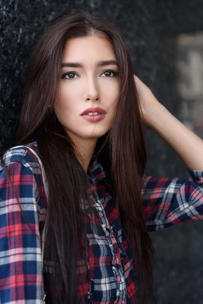 Cute young woman waiting near building — Stock Photo, Image