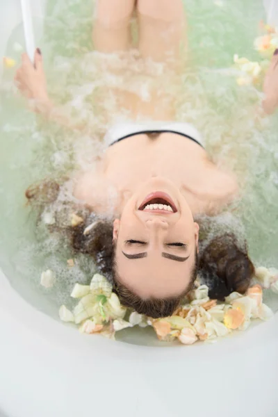 Joyful girl sitting in jacuzzi — Stock Photo, Image