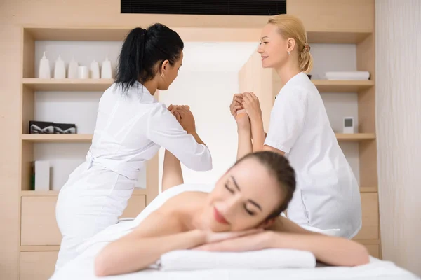 Professional masseuses doing massage for legs — Stock Photo, Image