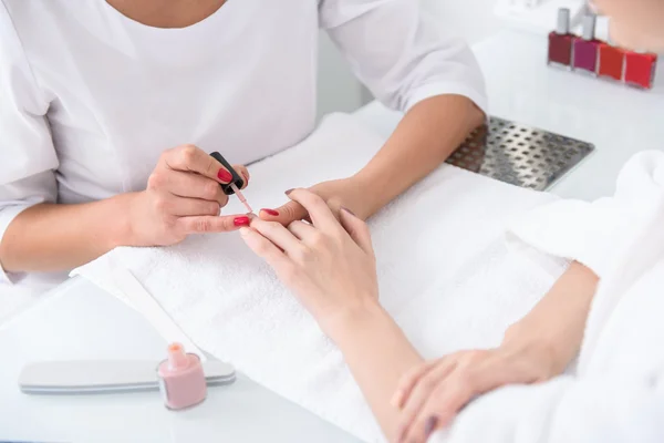 Skillful beautician doing manicure for girl — Stock Photo, Image