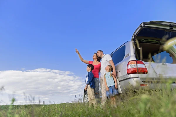 Sorrindo família feliz e seu carro — Fotografia de Stock