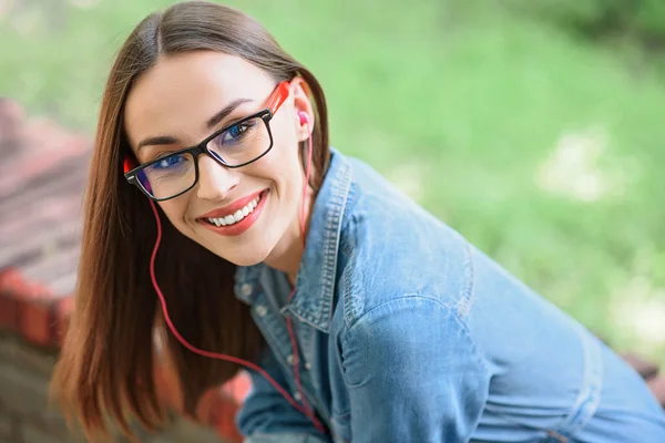 Dreamful young woman listening to song — Stock Photo, Image